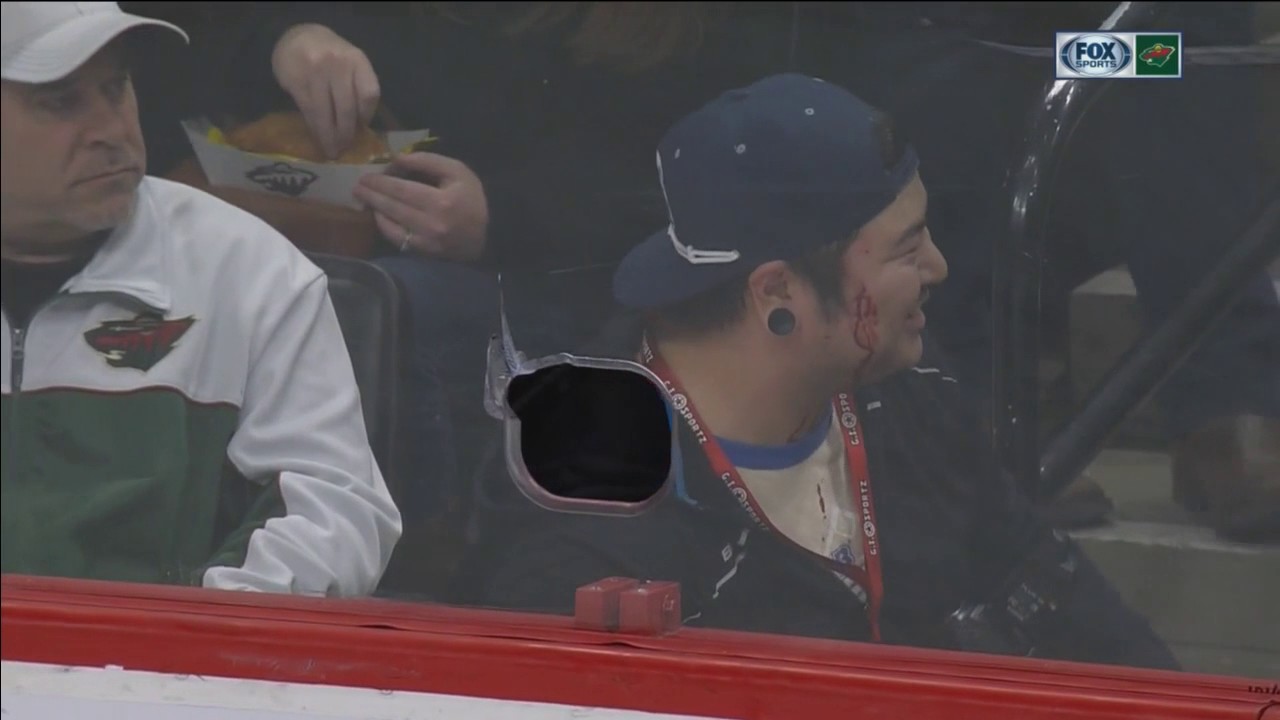 Wild player shoots puck through hole in glass, hits photographer